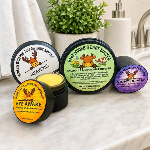 Moose's Tallow facial care lineup: Heavenly Whipped Body Butter, Baby Butter, Eye Awake, and Night Repair on a bathroom counter