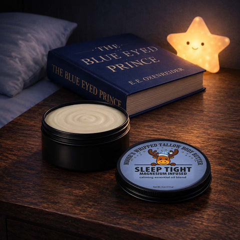 Open matte black tin of Sleep Tight magnesium body butter on a nightstand at bedtime