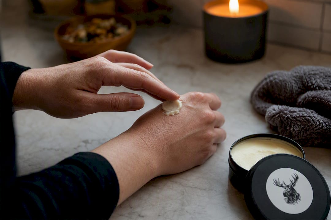 Applying magnesium balm onto forearm skin