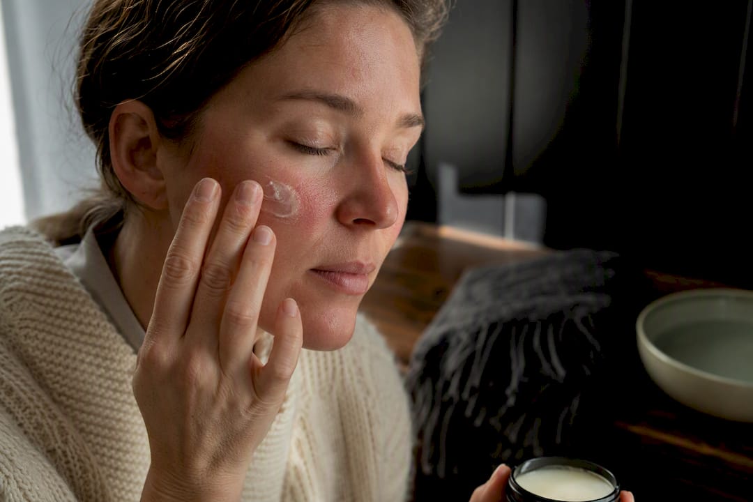 Applying balm to windburned cheek