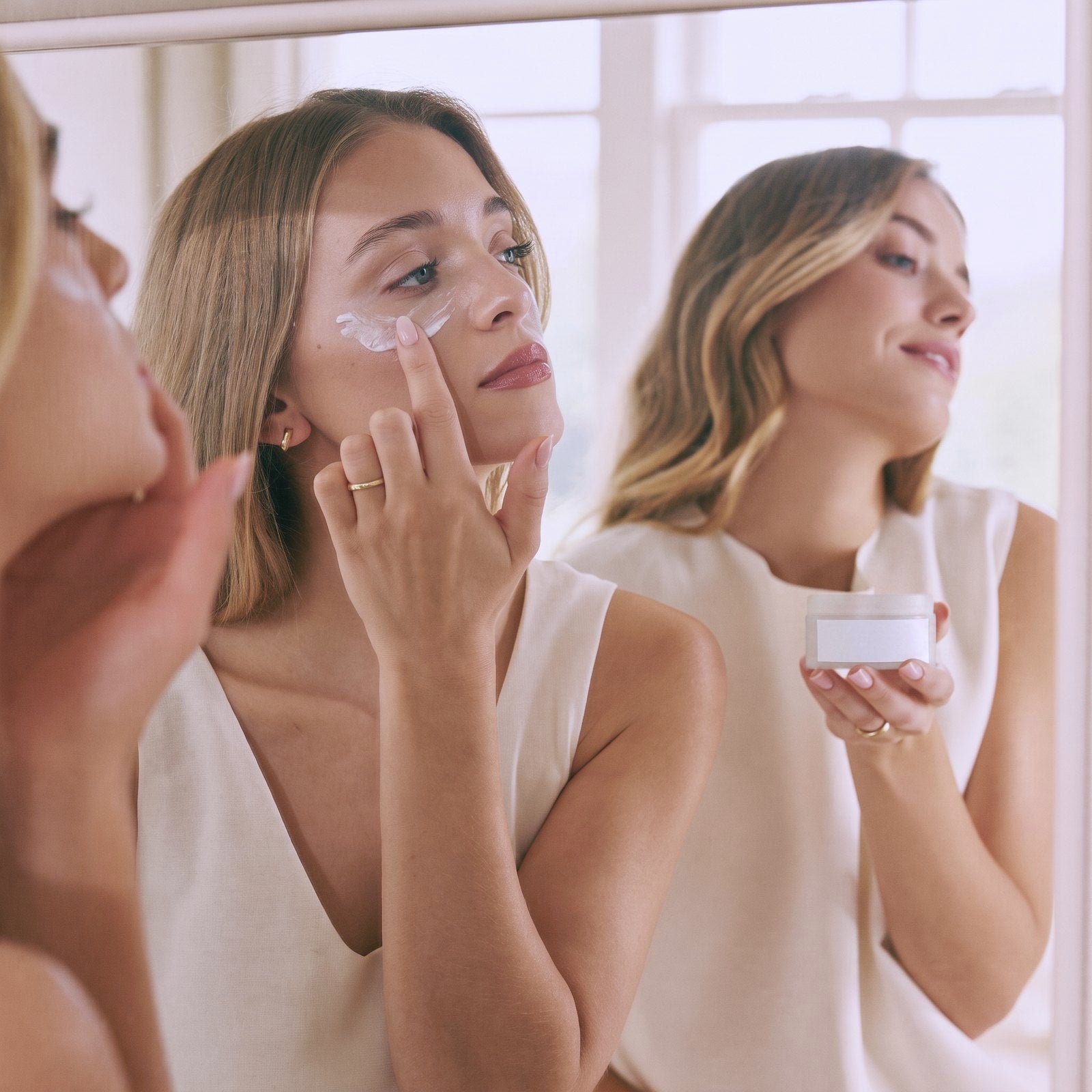 Two young women applying natural tallow eye cream while getting ready — Moose's Tallow bridal skincare gift sets
