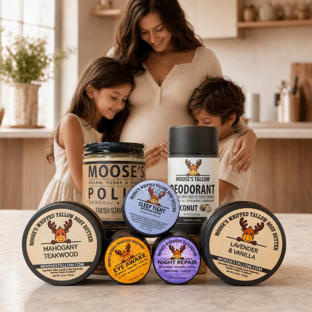 Pregnant mother in kitchen with her two children hugging her belly, surrounded by Moose's Tallow products: Sugar Polish, Deodorant, Sleep Tight, Mahogany Teakwood, Eye Awake, Night Repair, and Lavender & Vanilla