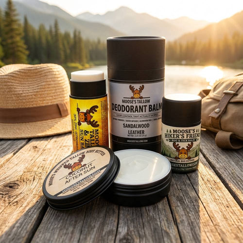 Natural Summer Skincare Essentials — Moose's Tallow zinc sun balm, deodorant, Hiker's Friend bug and tick balm, and coconut after sun butter by a summer lake