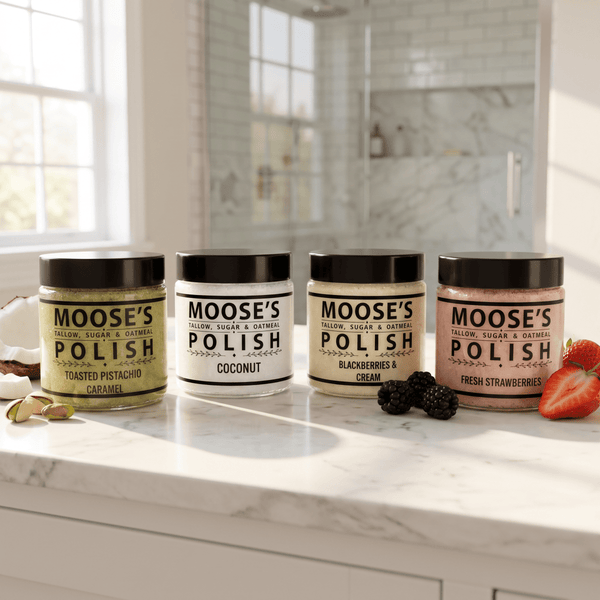 Set of four Moose's Tallow sugar and oatmeal body scrub jars on a bathroom counter