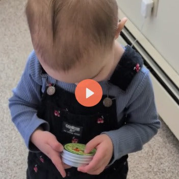 5-star video review for Natural Tallow Baby Butter: My toddler asks for it, toddler holding the tin - Kelly (square)