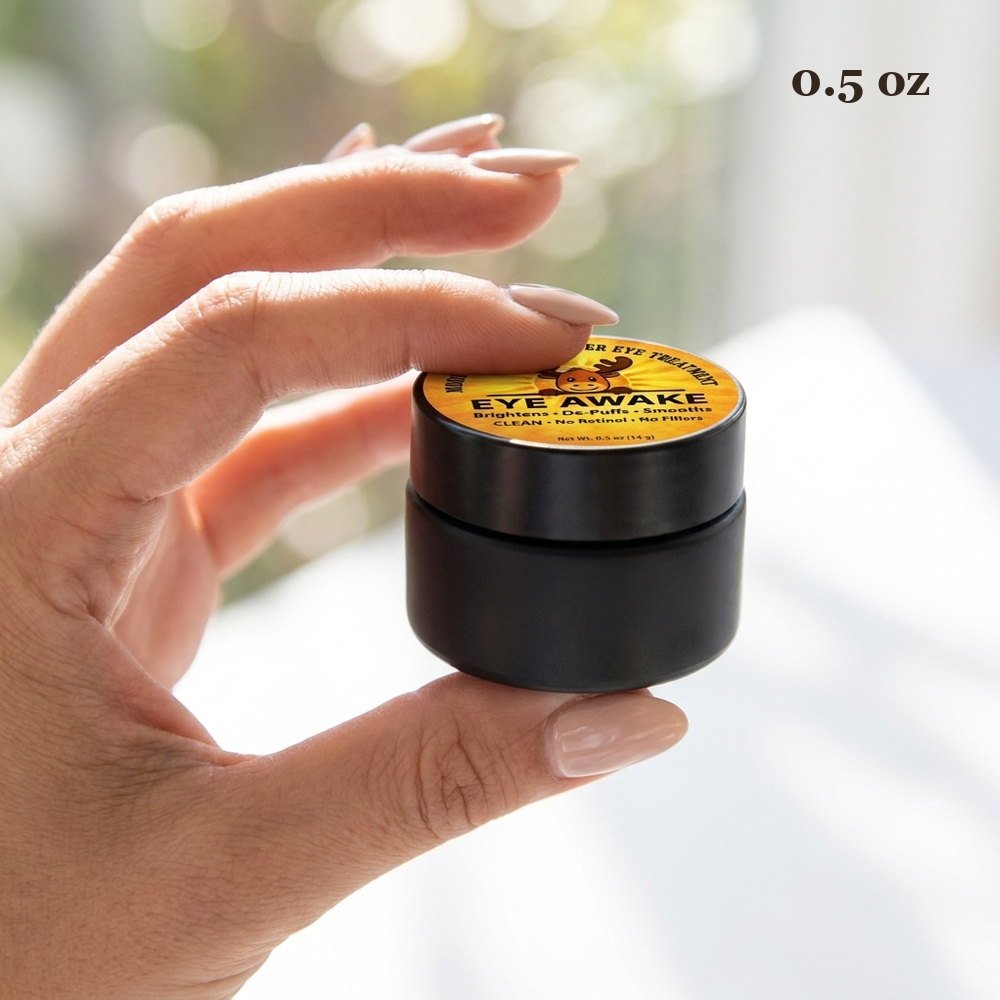 Hand holding the 0.5 oz Eye Awake jar, showing how small the container is