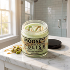 Toasted Pistachio Caramel Sugar Polish, open jar with the Moose's M pressed into the green scrub