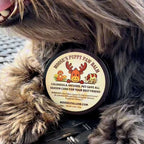 Moose's Puppy Paw Balm tin nestled in a dog's fur