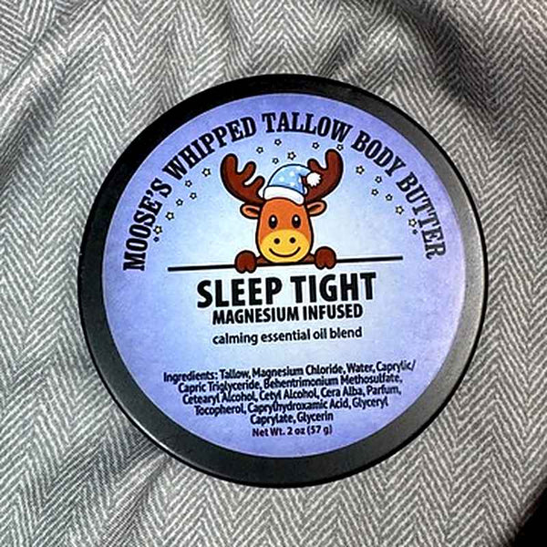 Moose's Sleep Tight Magnesium Whipped Tallow Body Butter tin on a cozy blanket